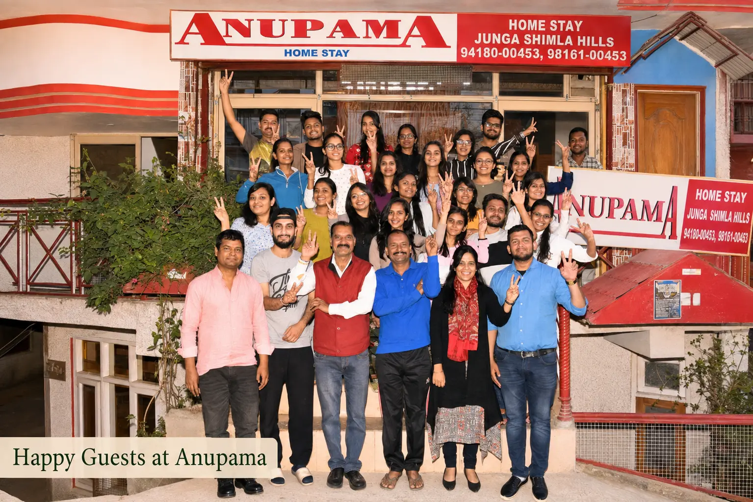 Happy guests and hosts gathered outside Anupama Home Stay