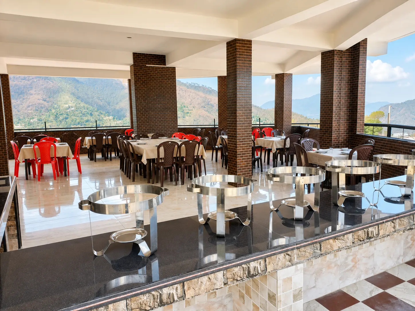 Bright dining hall and buffet space at Anupama Home Stay restaurant