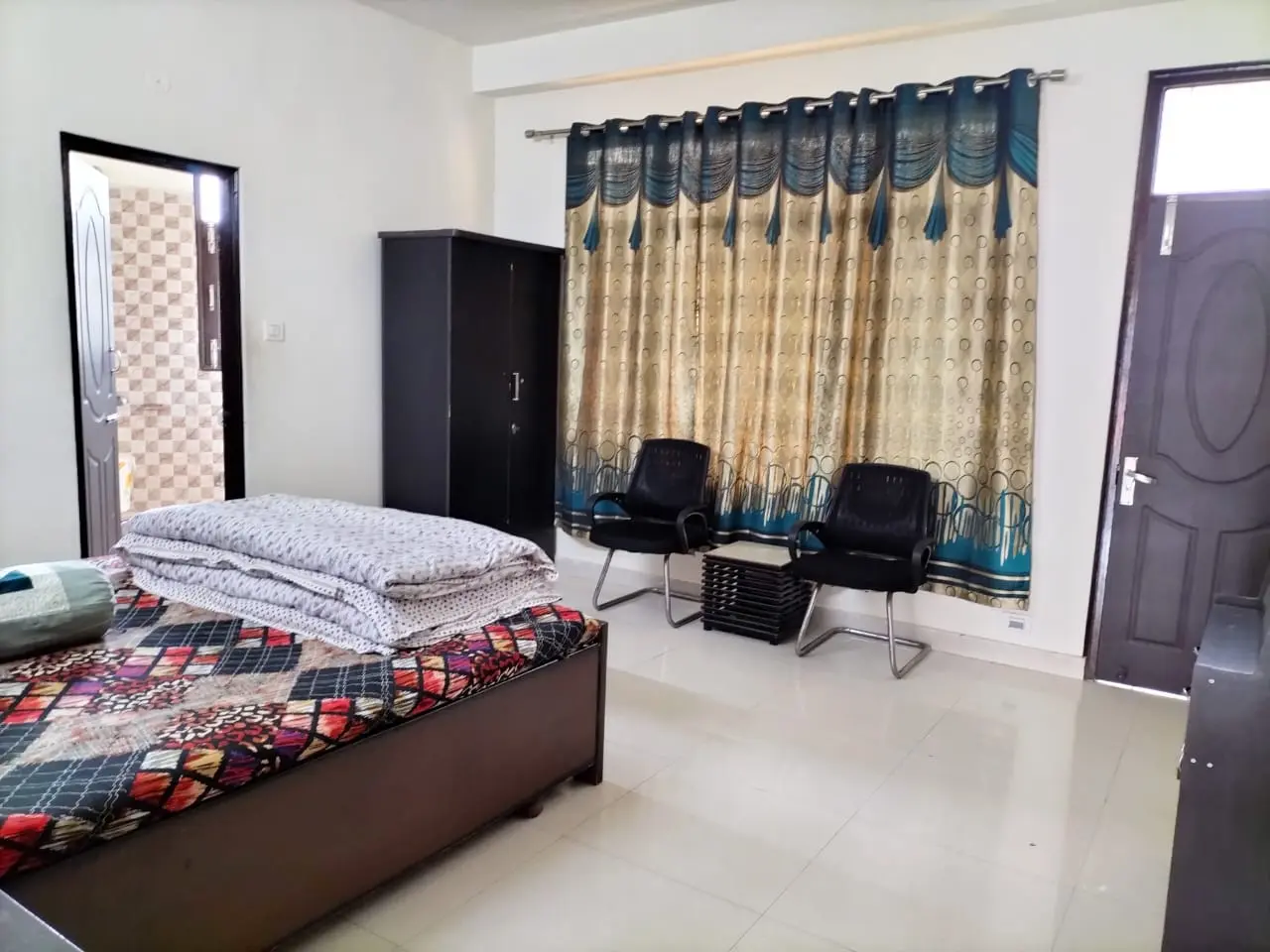 Guest room at Anupama Home Stay with double bed, television and seating